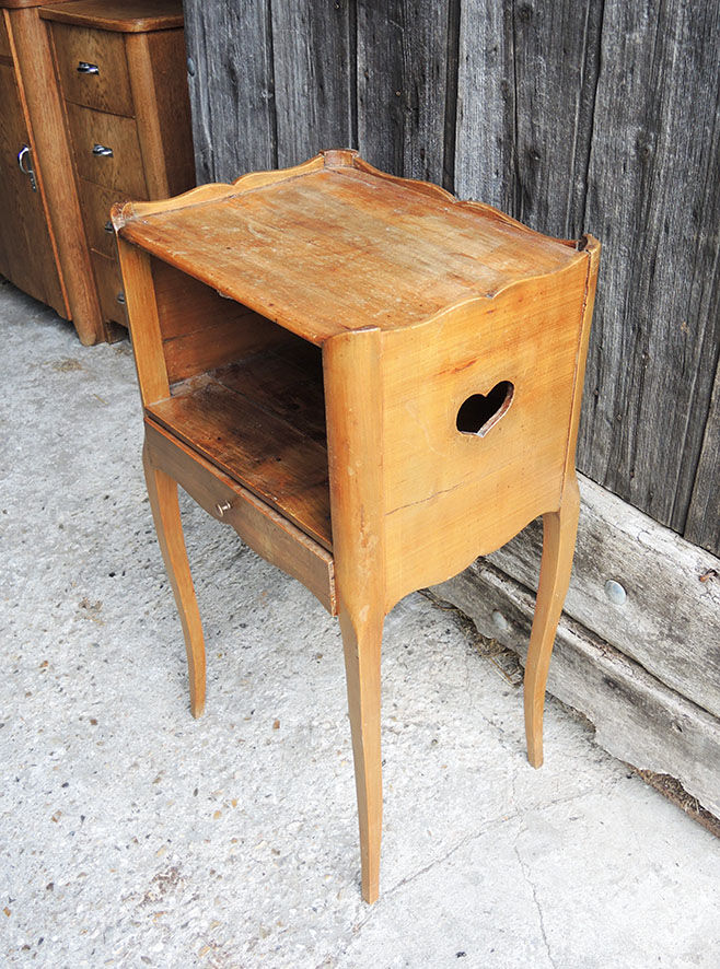 Old wooden bedside table heart pattern