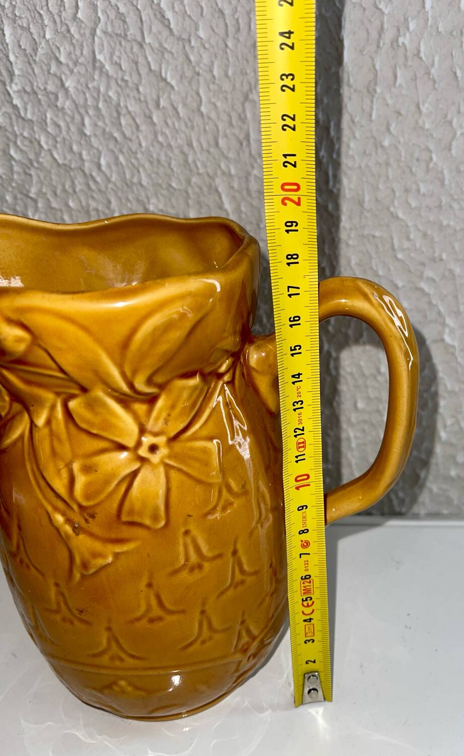 Antique pitcher with flower decoration