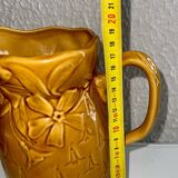 Old pitcher decorated with flowers