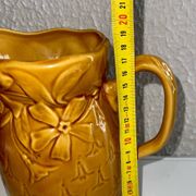 Antique pitcher with flower decoration