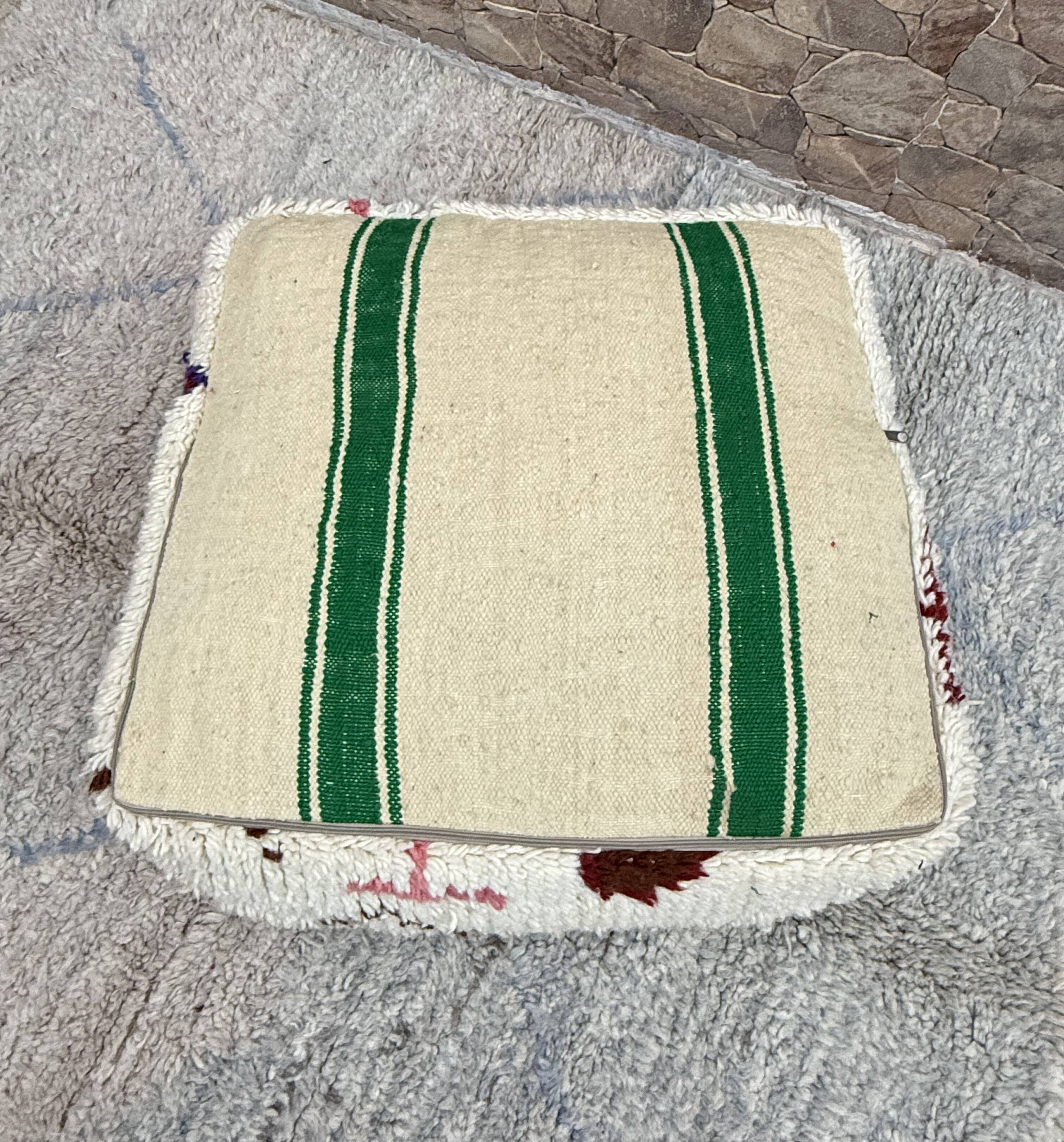 Berber floor pouf: Handwoven Moroccan wool cushion.