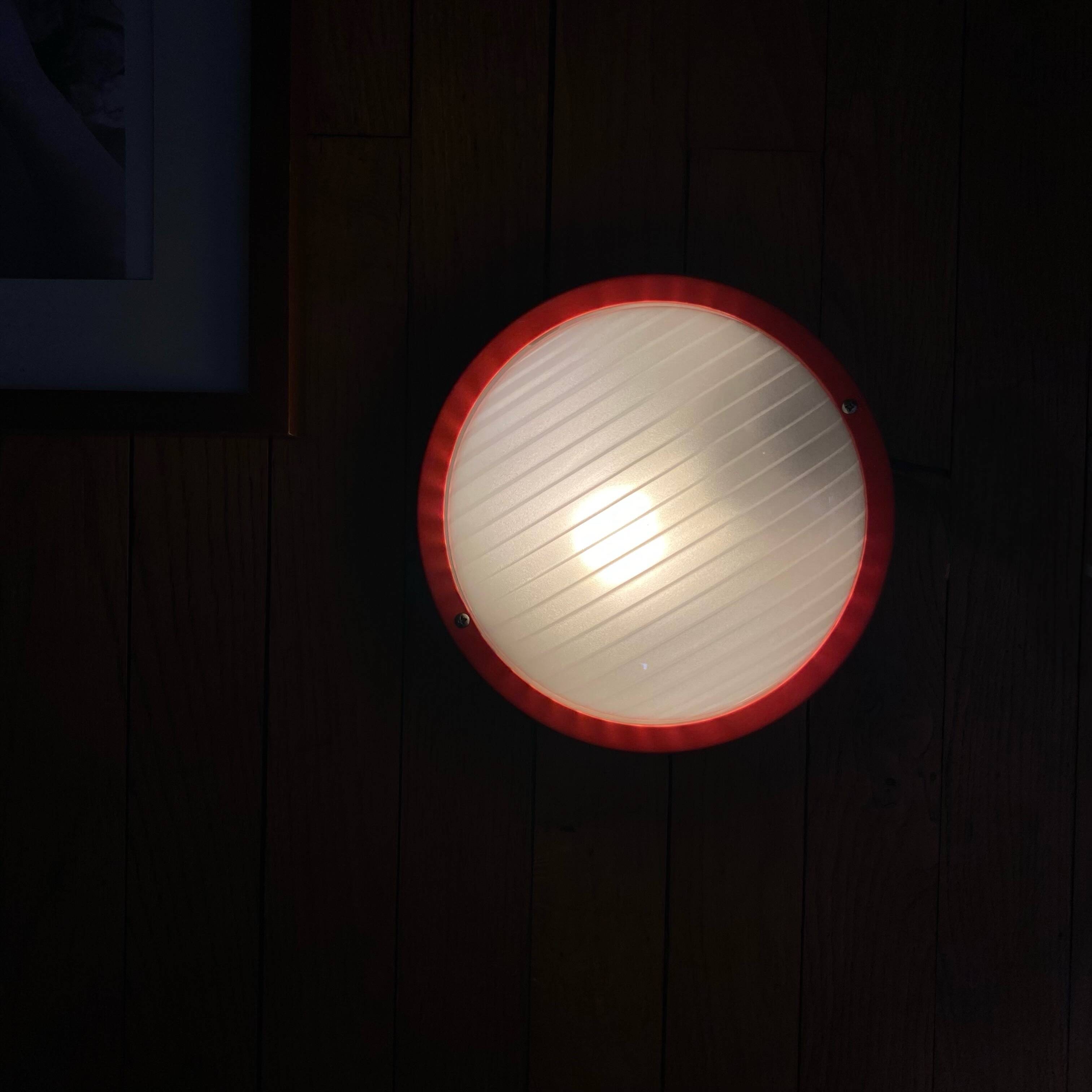 Round glass wall-mounted ceiling light porthole Prisma model Eko red.