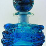 Blown blue glass bottle with inclusions