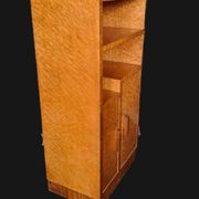 Art Deco cabinet in speckled maple veneer with asymmetrical shelves.