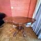 Antique mahogany table with a scalloped top and a sculpted central leg.