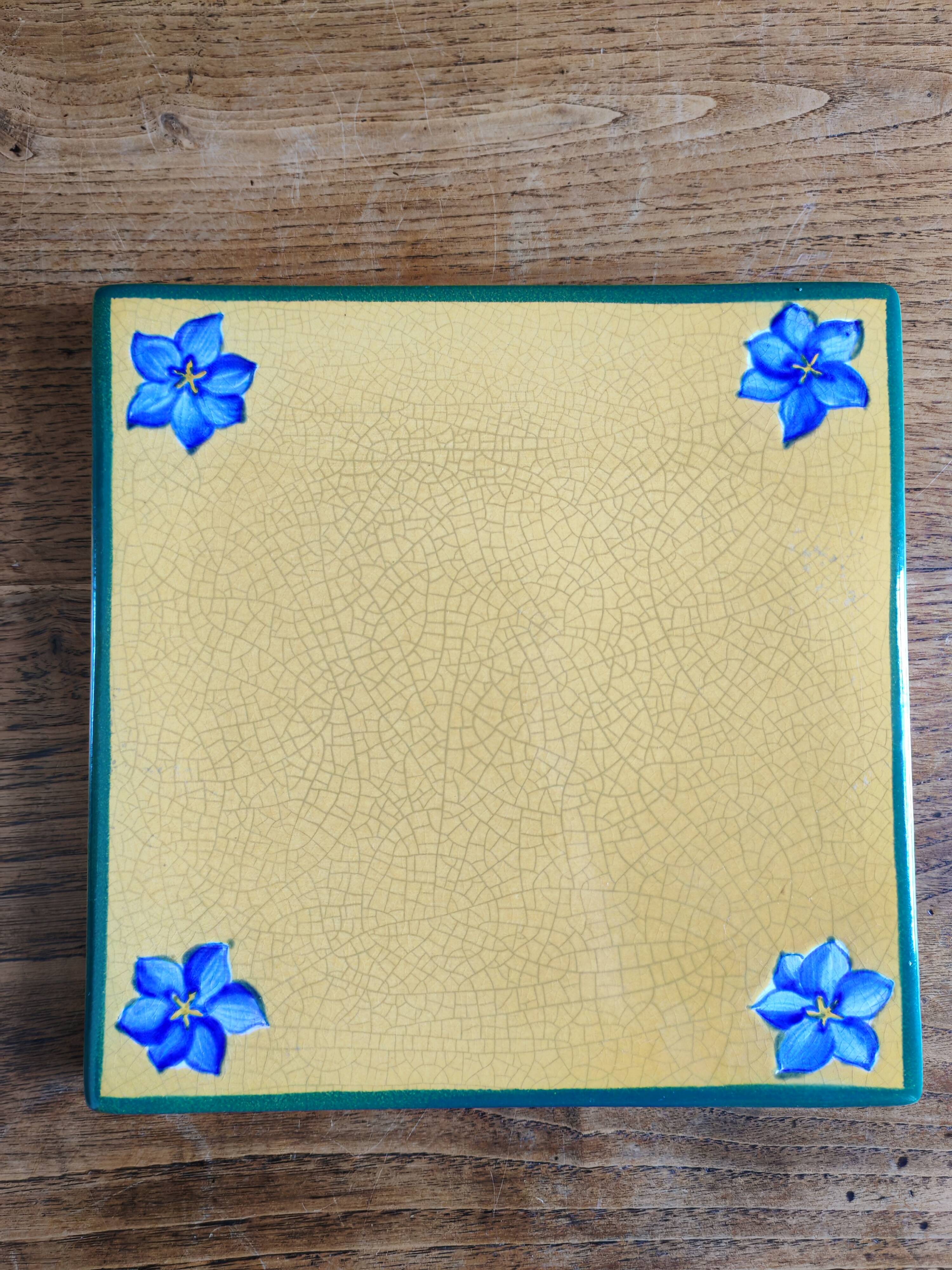 Yellow glazed ceramic trivet signed l. drimmer