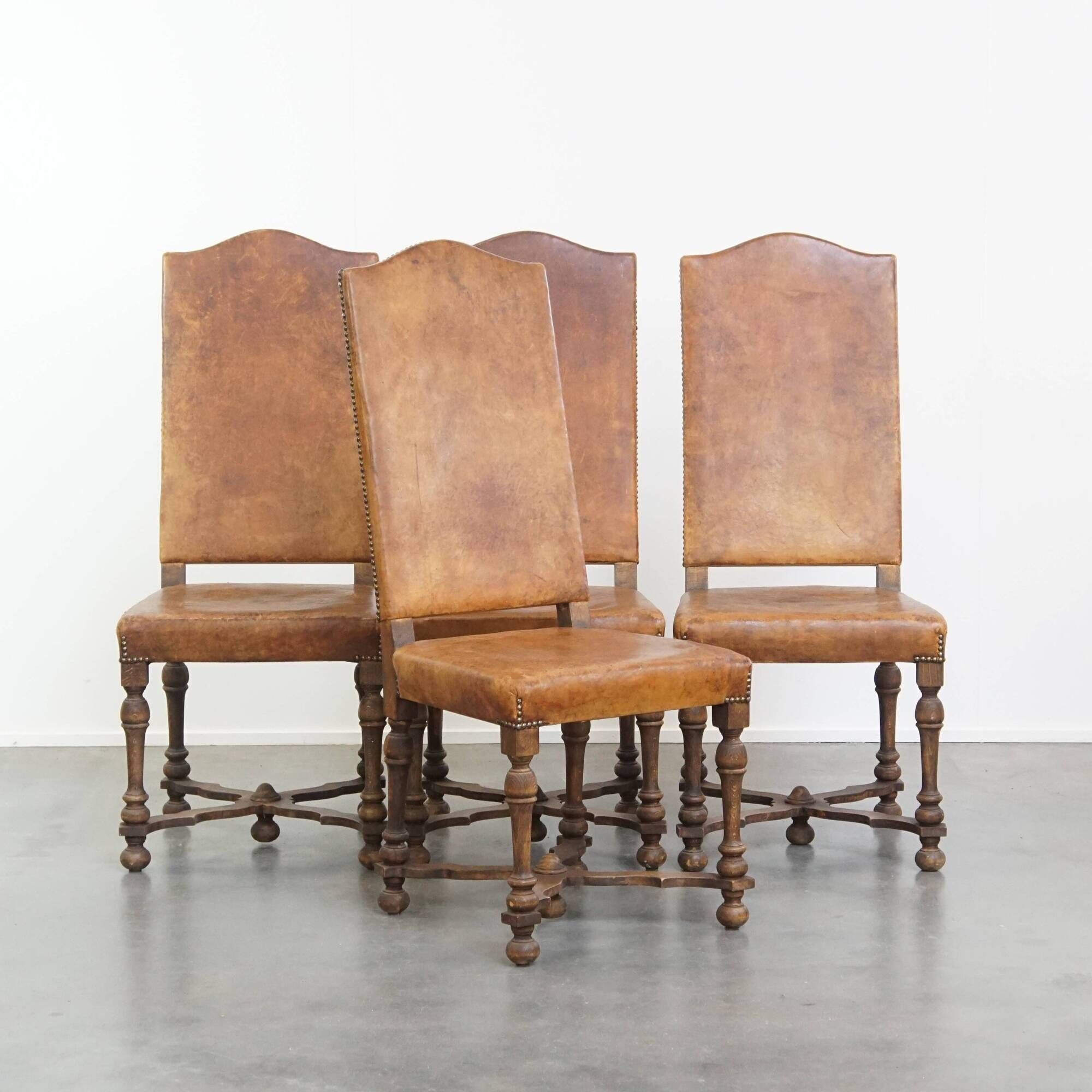 Set of 4 antique wooden and sheepskin leather dining chairs