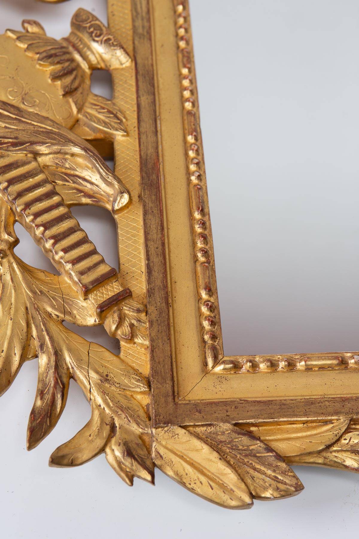 French gold mirror with a Louis XVI style pediment c. 1940/50 (95*54 cm)