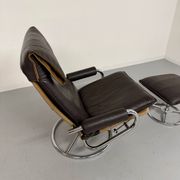 Vintage leather reclining armchair and its 1970s designer ottoman.