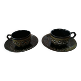 Black cups and saucers with relief decoration