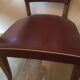 Skai chair binds wine and wooden footpieces and armrests