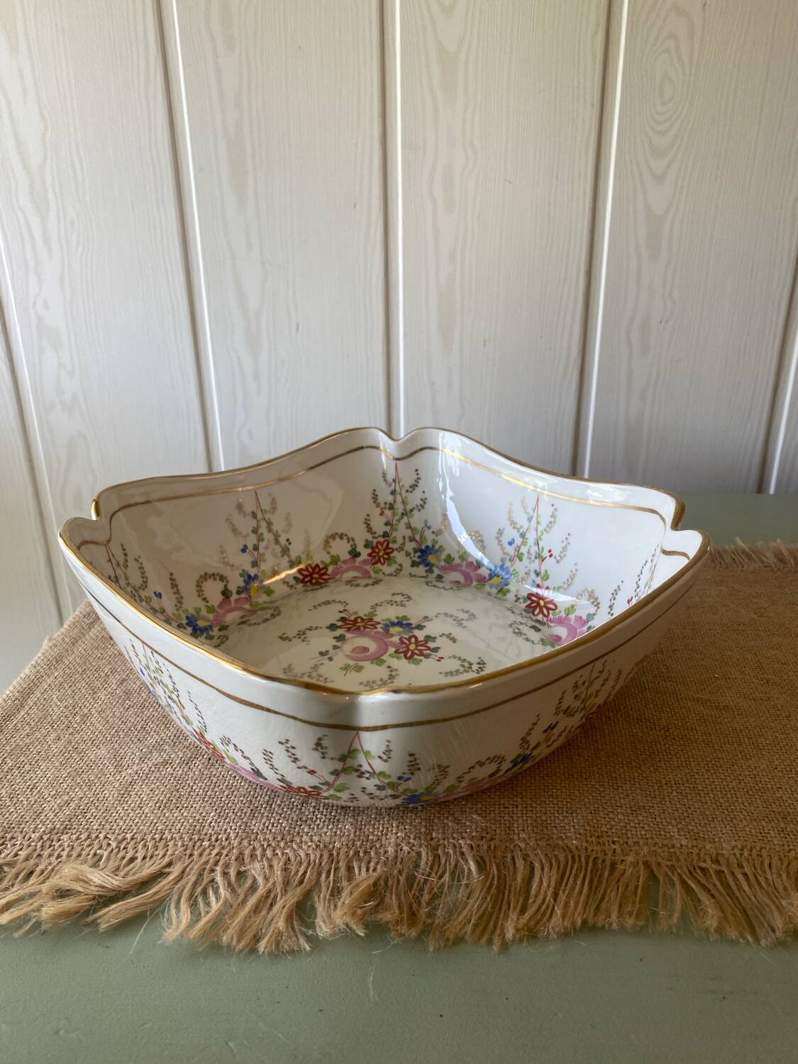 Old hollow porcelain dish with floral decoration and gold trim