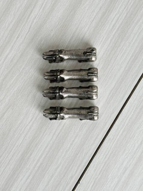 Antique metal knife rest in the shape of a dog.