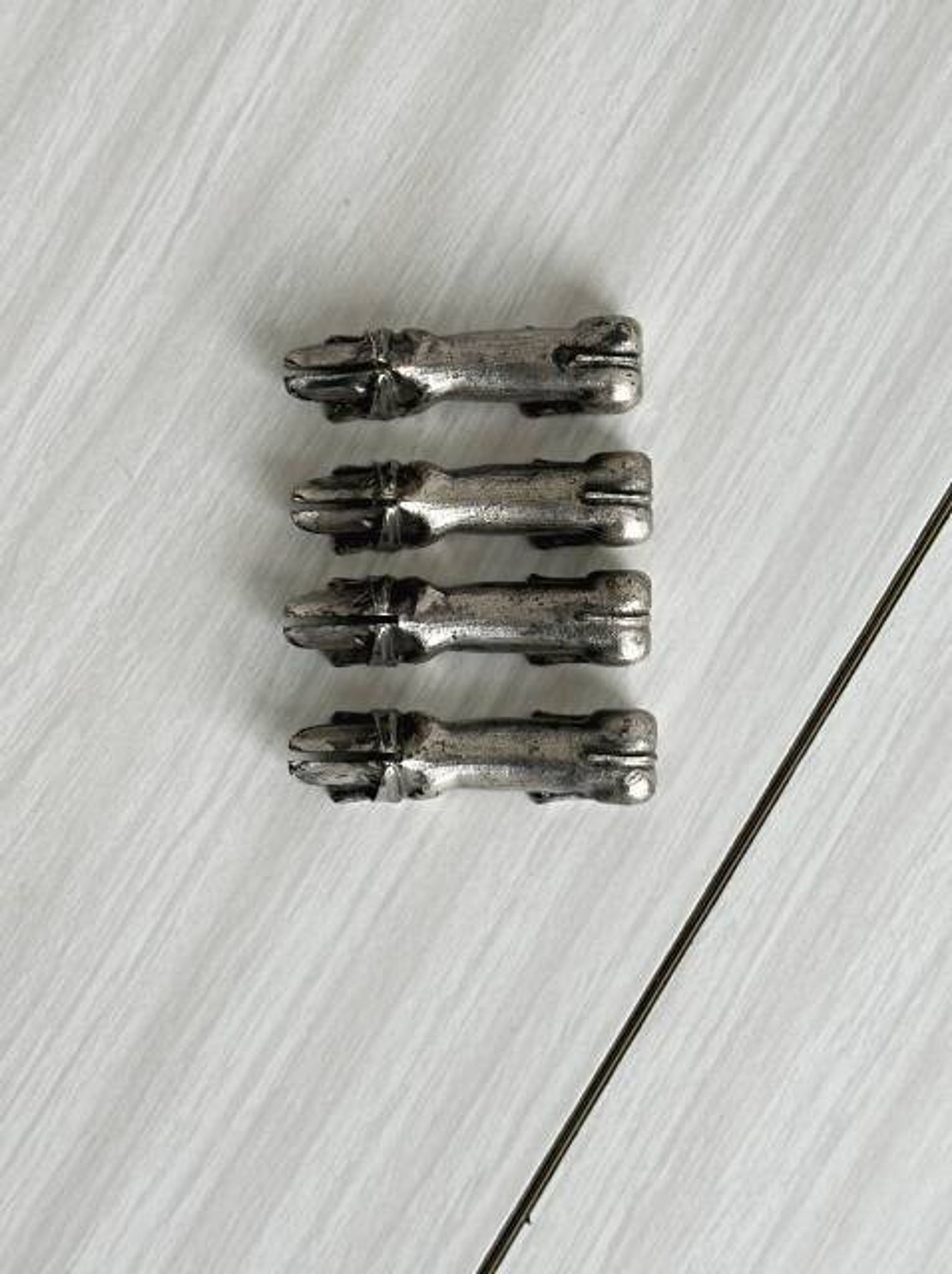 Antique metal knife rest in the shape of a dog.