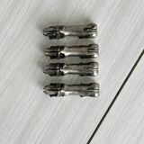 Antique metal knife rest in the shape of a dog.