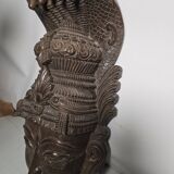 Ancient Indian carved wooden mask sculpture of a deity with a cobra.