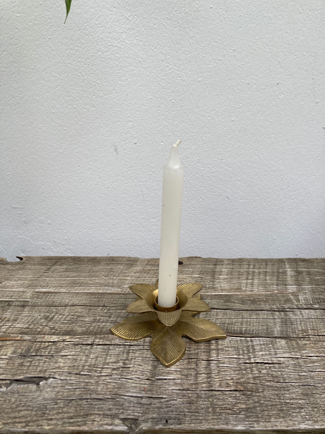 Old golden brass candle holder in the shape of a leaf or flower