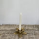 Old golden brass candle holder in the shape of a leaf or flower