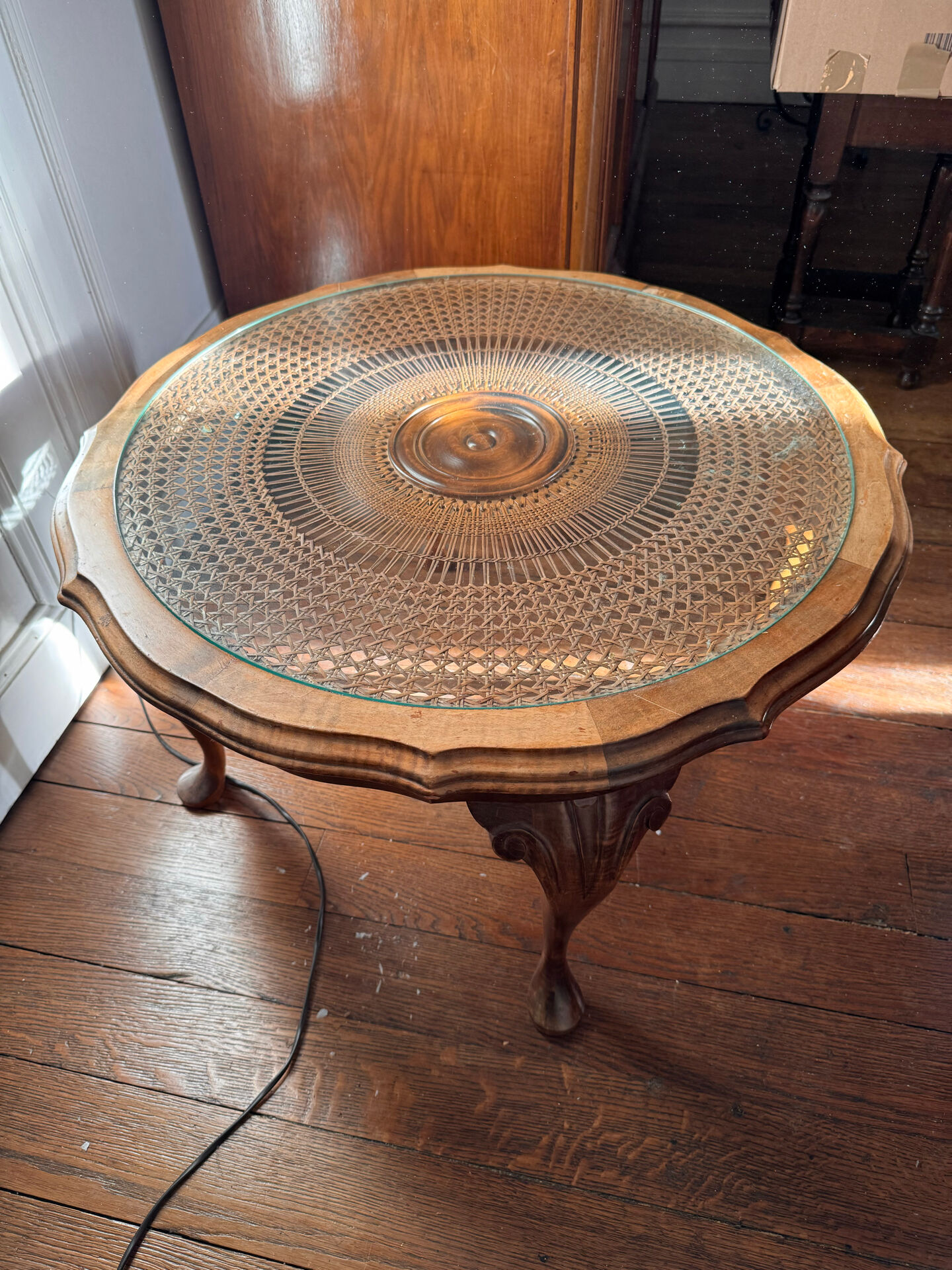Round coffee table in Louis XV style, with sun cane and glass top.