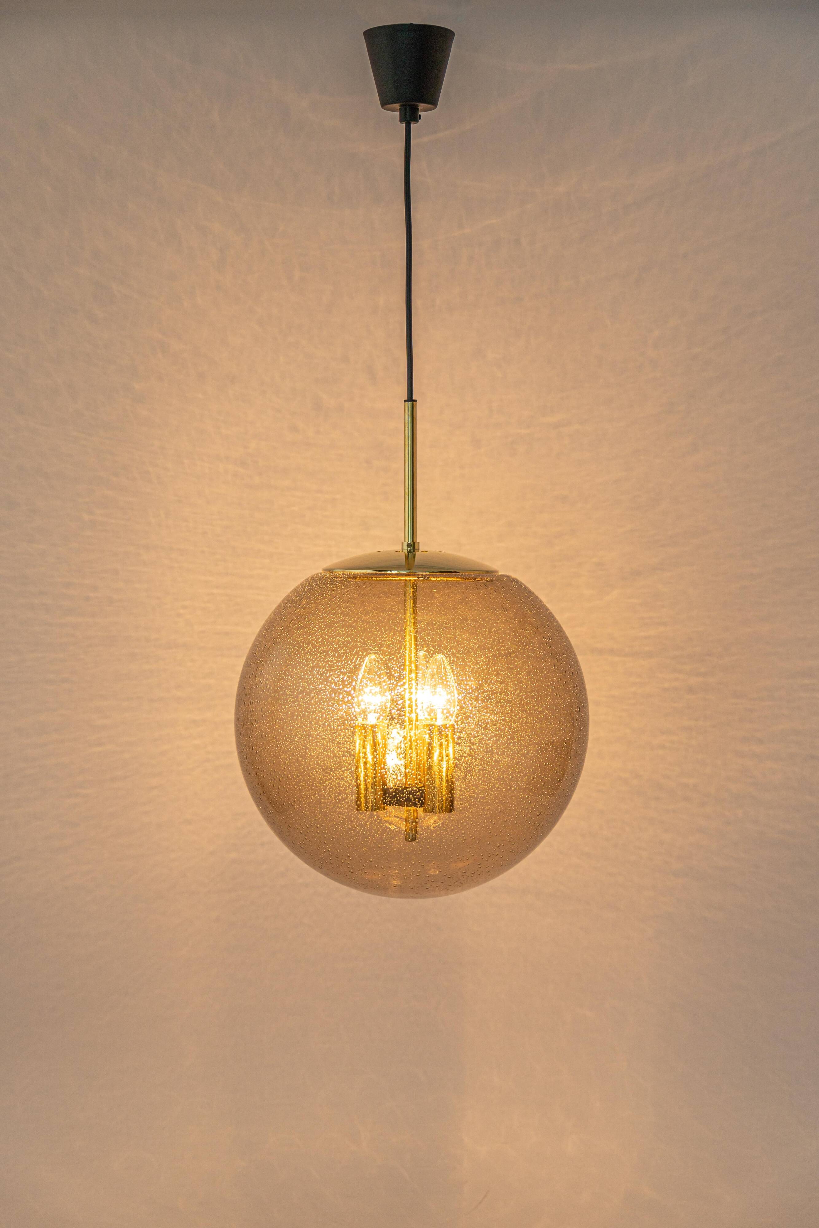 Large Limburg pendant light in brass with smoked glass ball, Germany, 1970s.