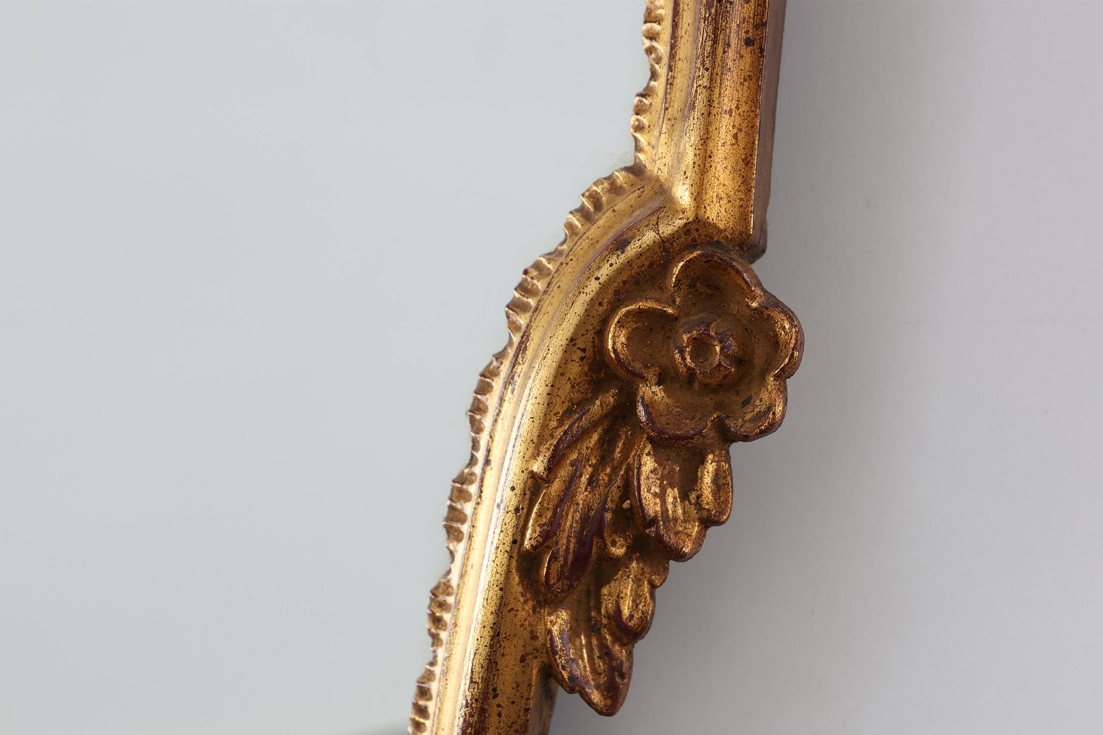 20th Century Louis XVI style giltwood mirror with ornate crest, France