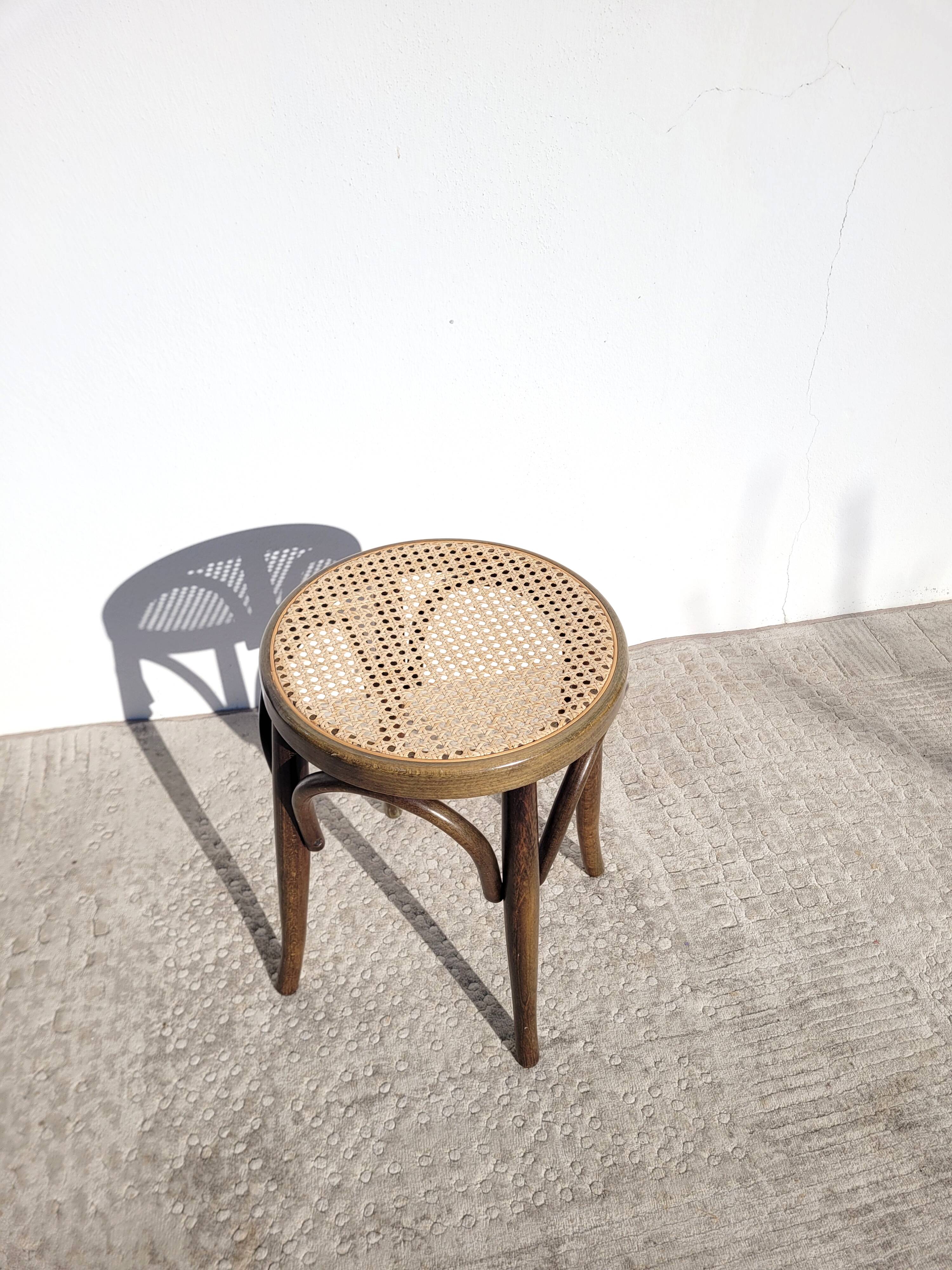Low stool in cane and curved wood