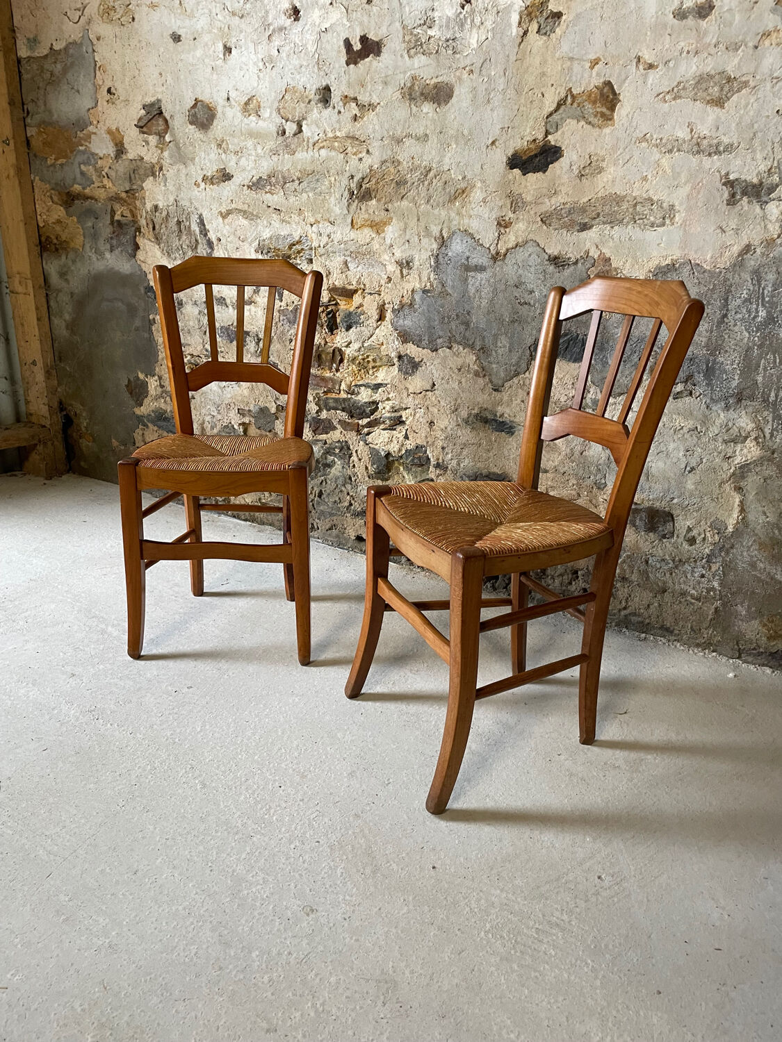 Set of 2 antique wooden and straw chairs.
