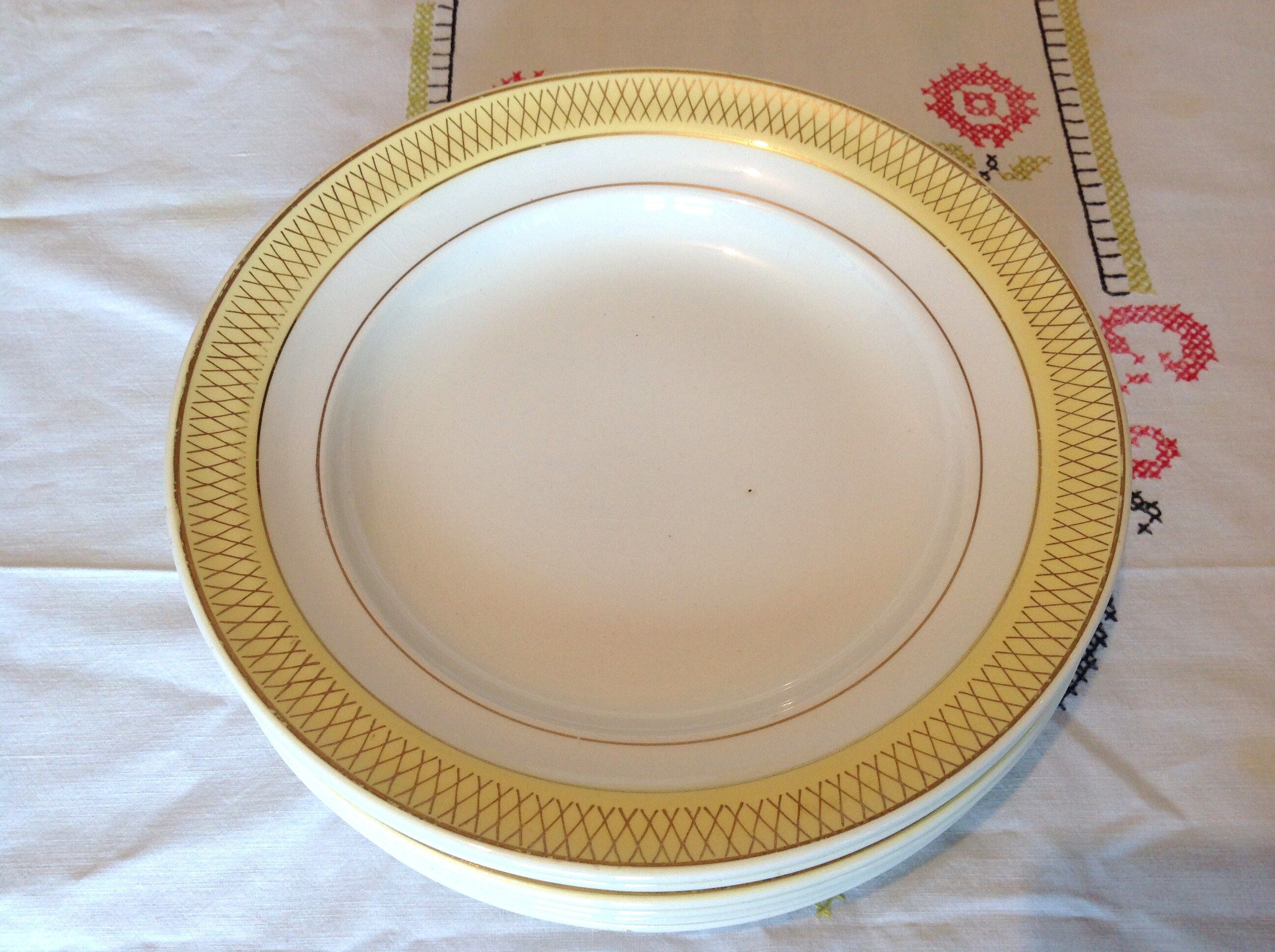 Six white hollow plates on board yellow Monaco 60