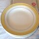 Six white hollow plates on board yellow Monaco 60