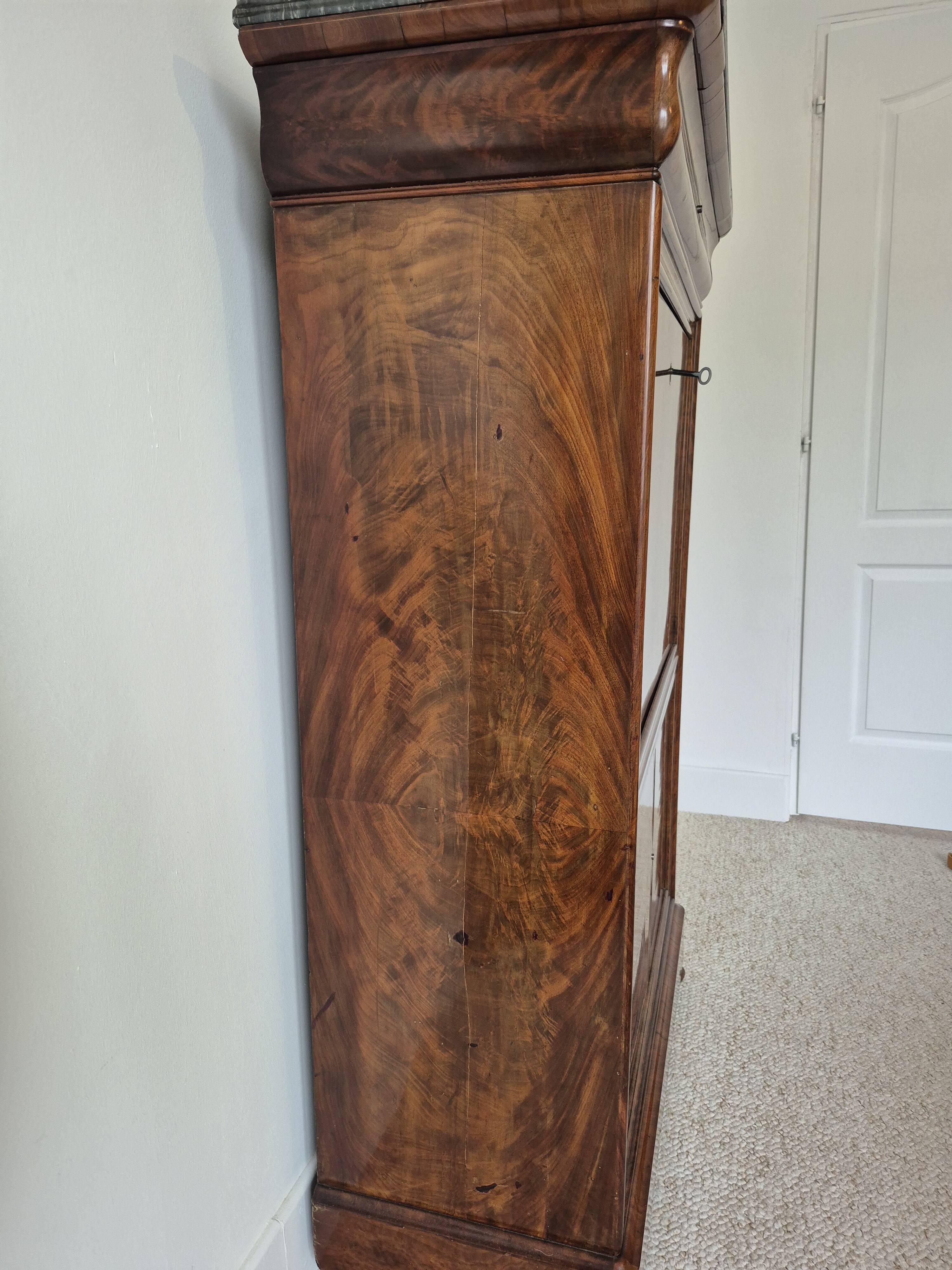 Mahogany secretary desk with marble top and interior mirror.