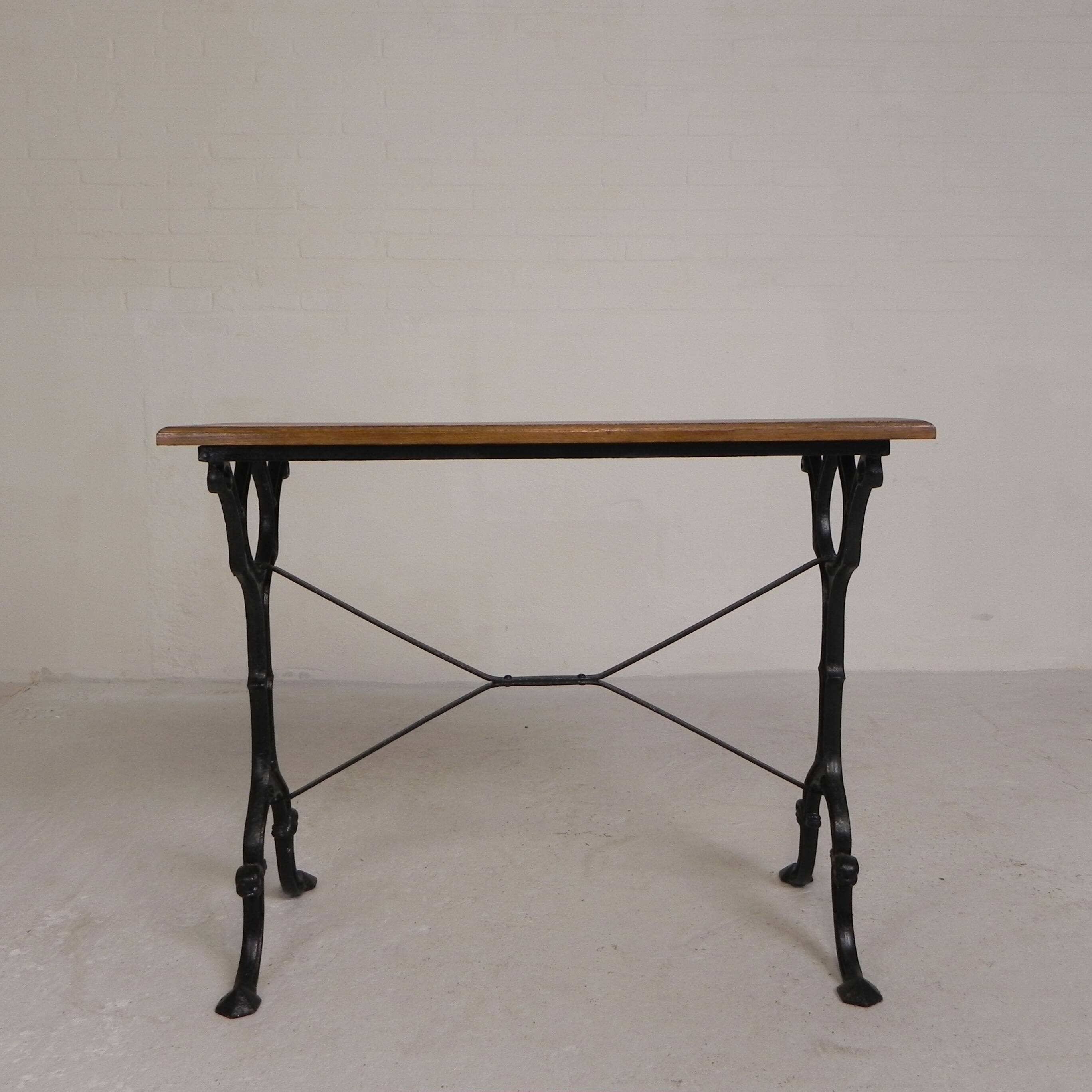 Bistro table with an oak top on a cast iron base, 1930s.