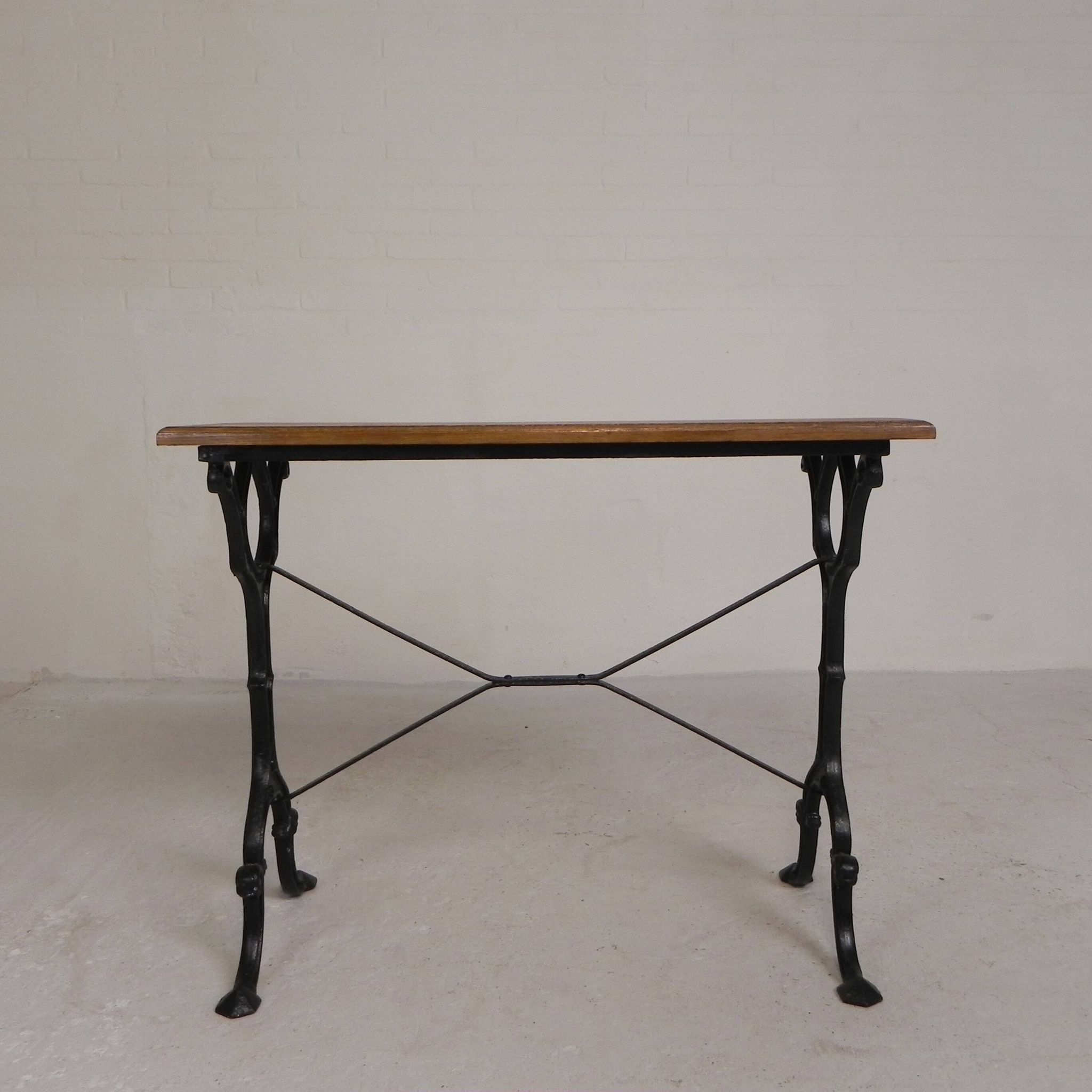Bistro table with an oak top on a cast iron base, 1930s.
