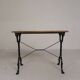 Bistro table with an oak top on a cast iron base, 1930s.