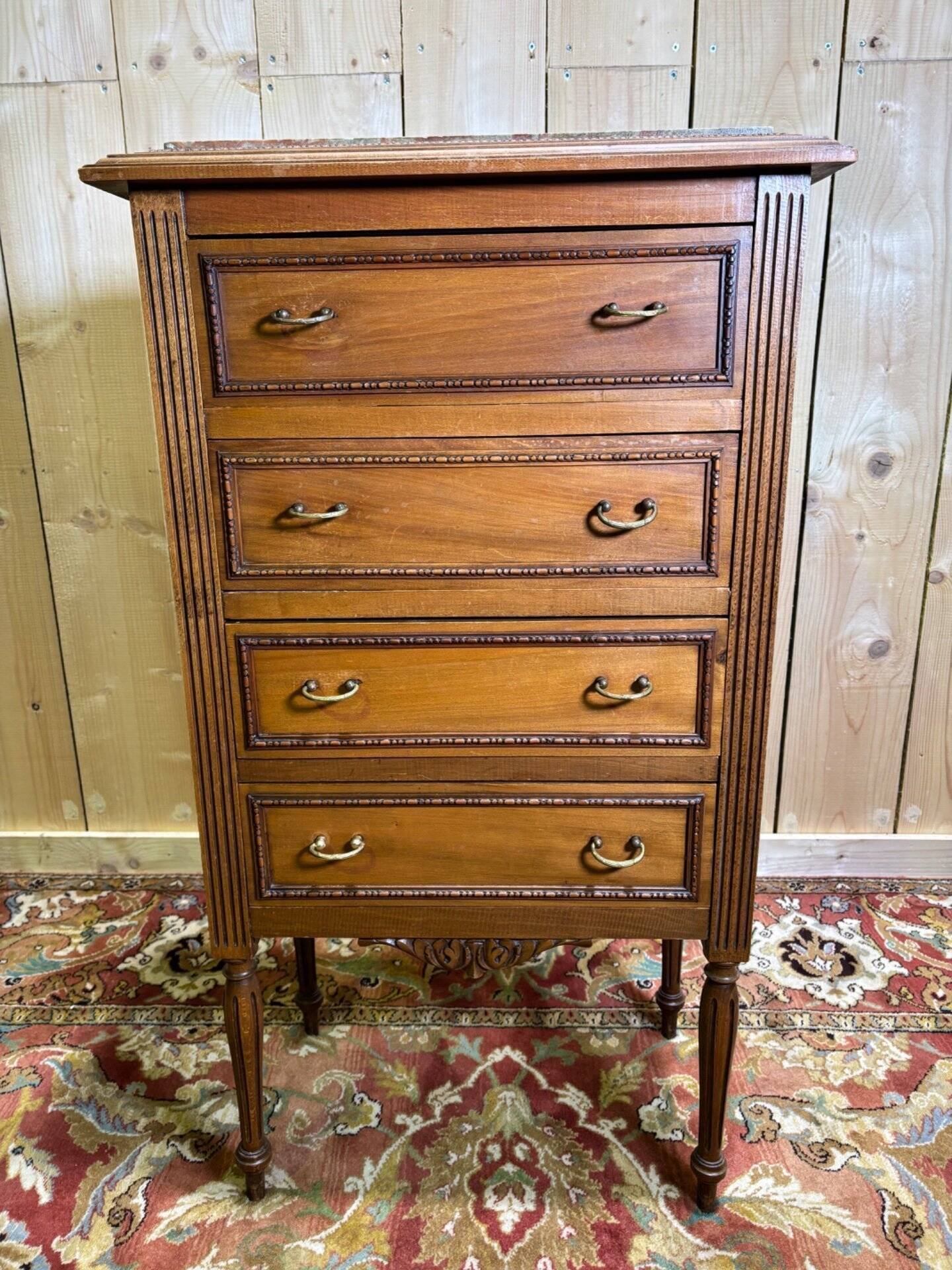 Louis XVI style molded and carved walnut chest of drawers