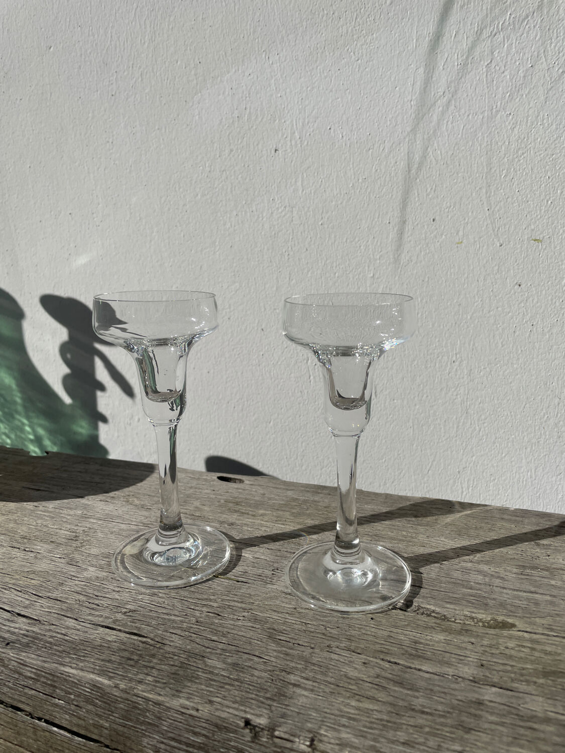 Pair of clear glass candlesticks, signed