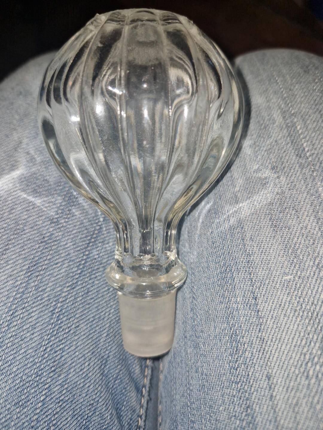 Antique cut glass spirit decanter with silver-plated neck and spout.
