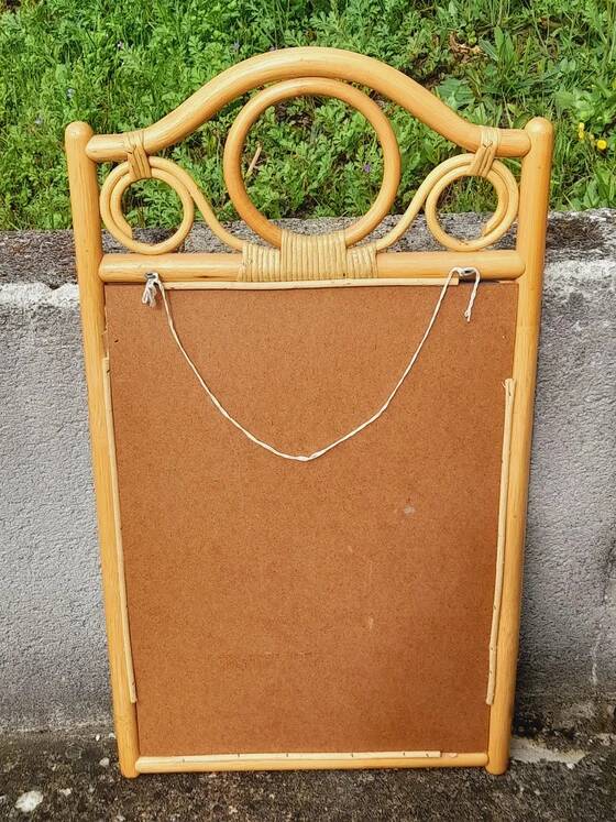 Curved wooden mirror and rattan