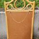 Curved wooden mirror and rattan