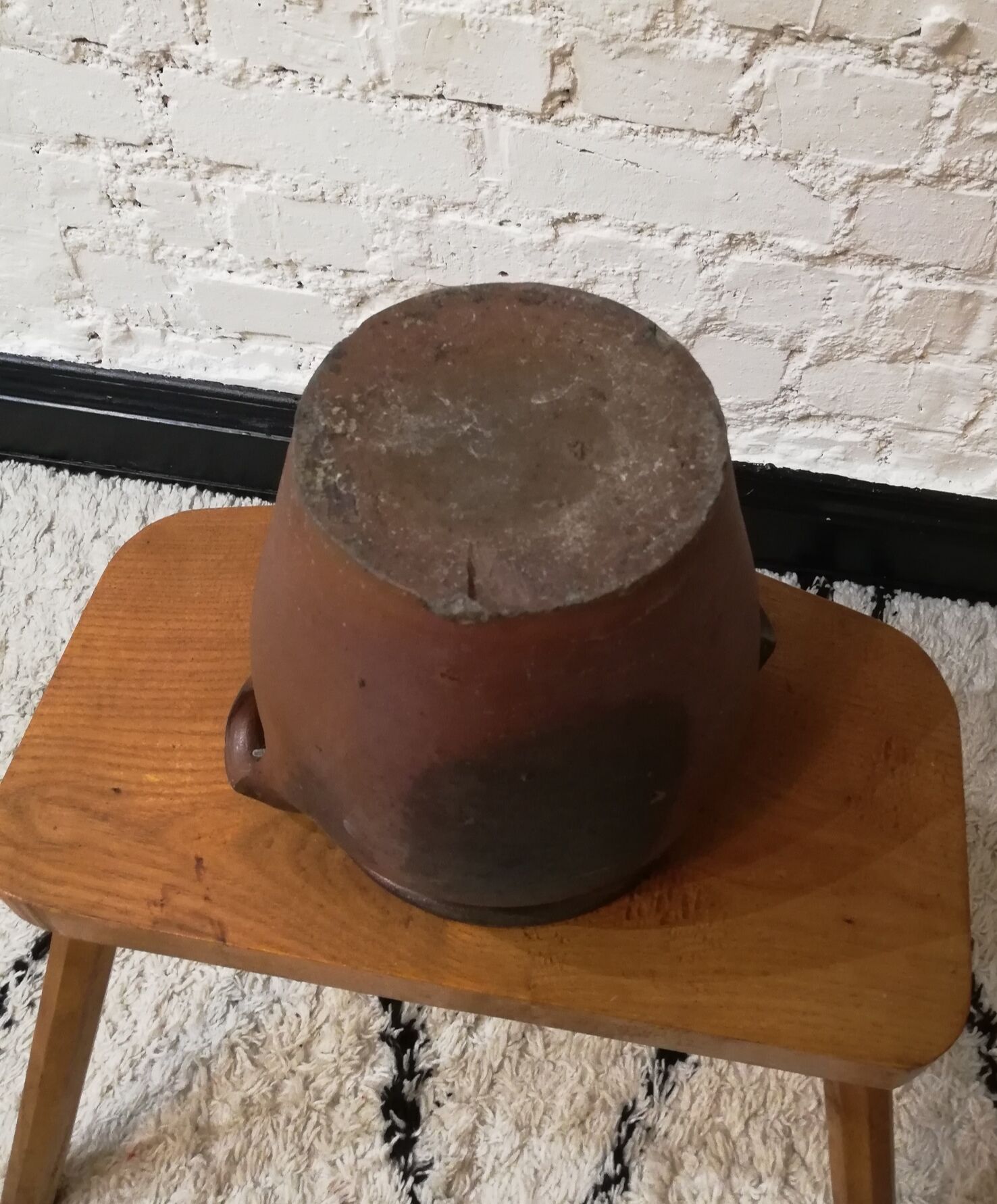 Old red and black terracotta grease pot