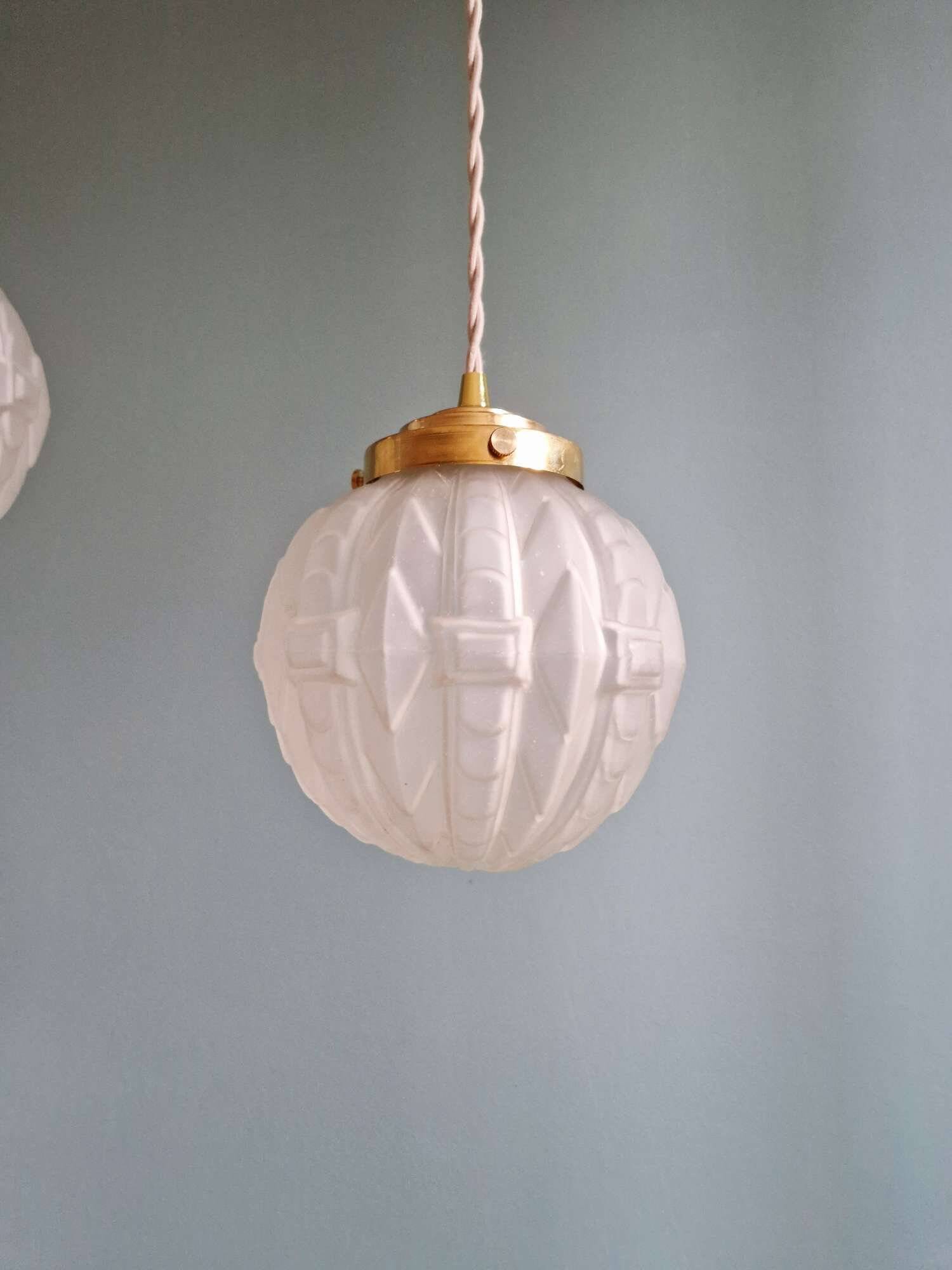 Pair of Art Deco pendant lights in pressed molded satin glass, 1920-30