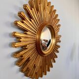 Old large golden sun mirror with rounded witch's eye in vintage resin from the 70s