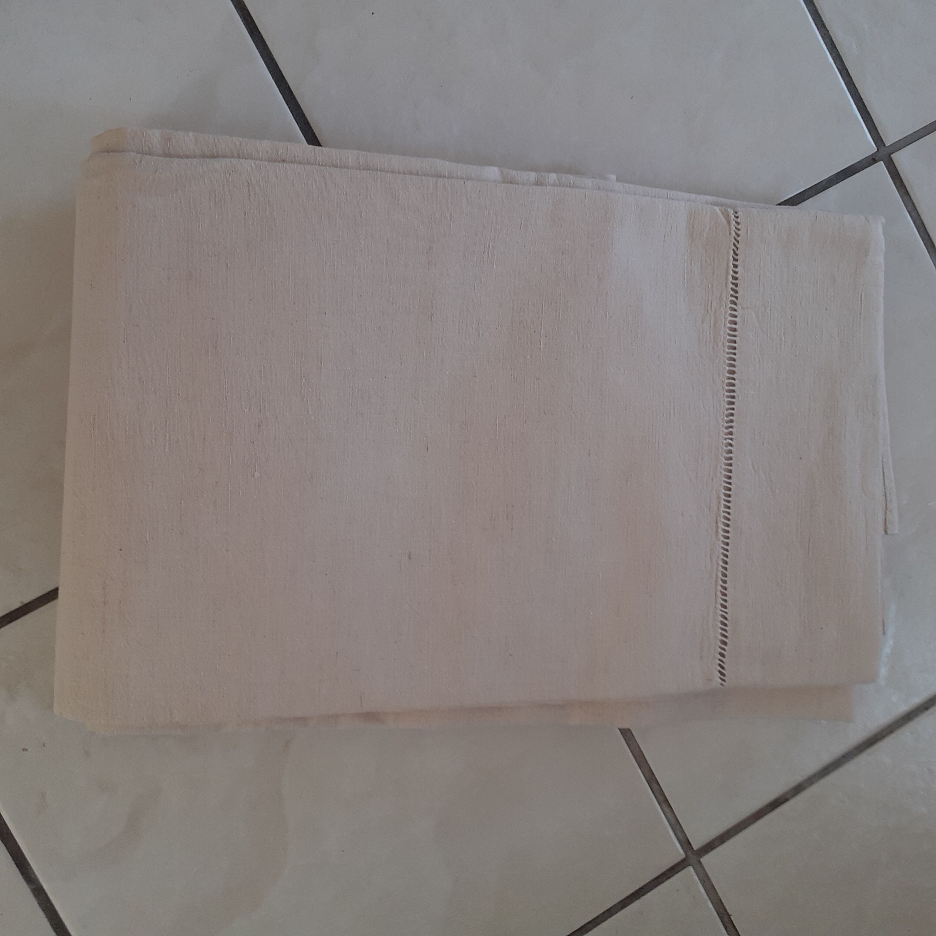 Linen sheet, bordered by a handmade day
