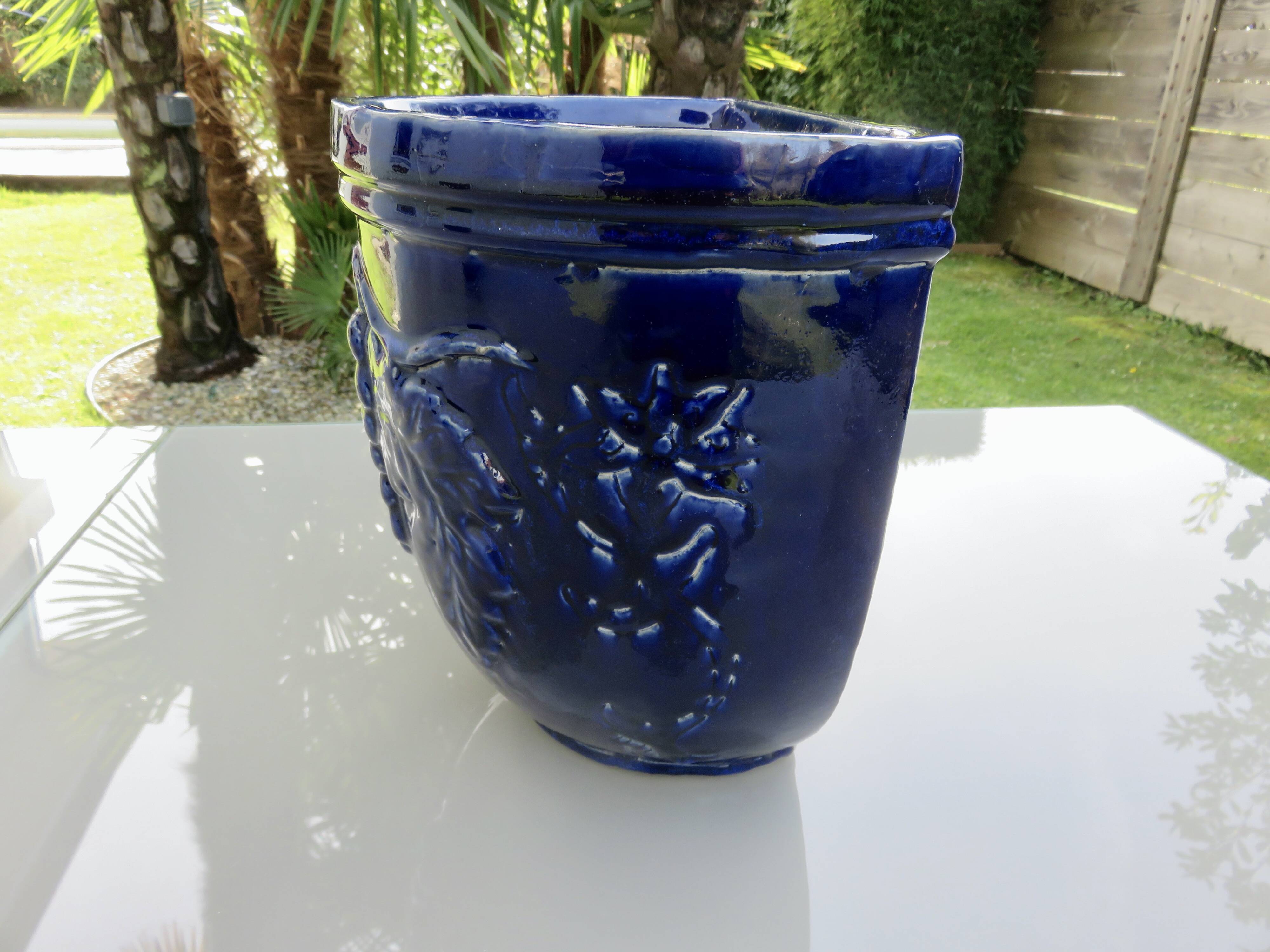 Wall pot in glazed blue terracotta with a grape motif, 1970s.