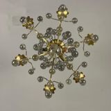 Gilded bronze chandelier trimmed with drop-shaped stamps