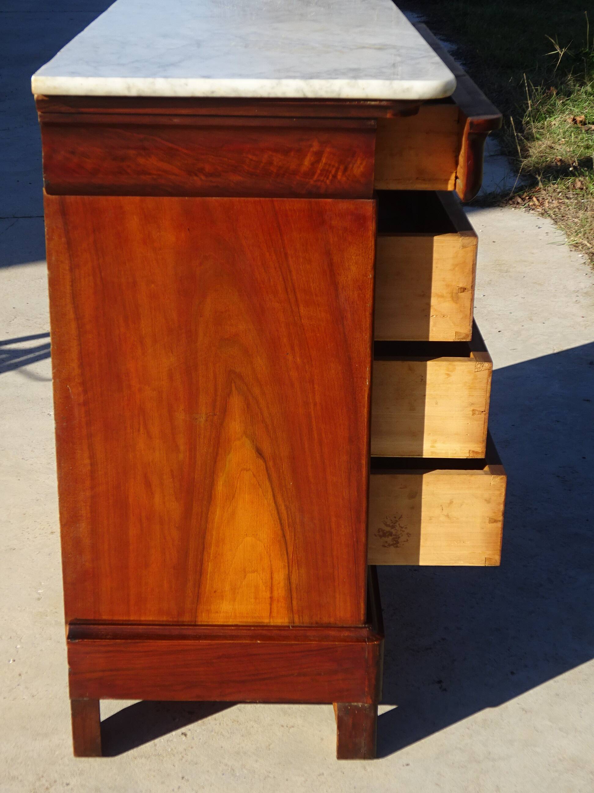 Antique mahogany chest of drawers with white marble.