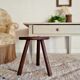 Old wooden tripod wooden farm stool made of wood