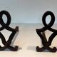 Pair of Modernist Andirons in Cast Iron with Stylised Figure Supports, by Ray