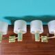 Pair of brass and gold plastic sconces with granite lampshades, France 1950