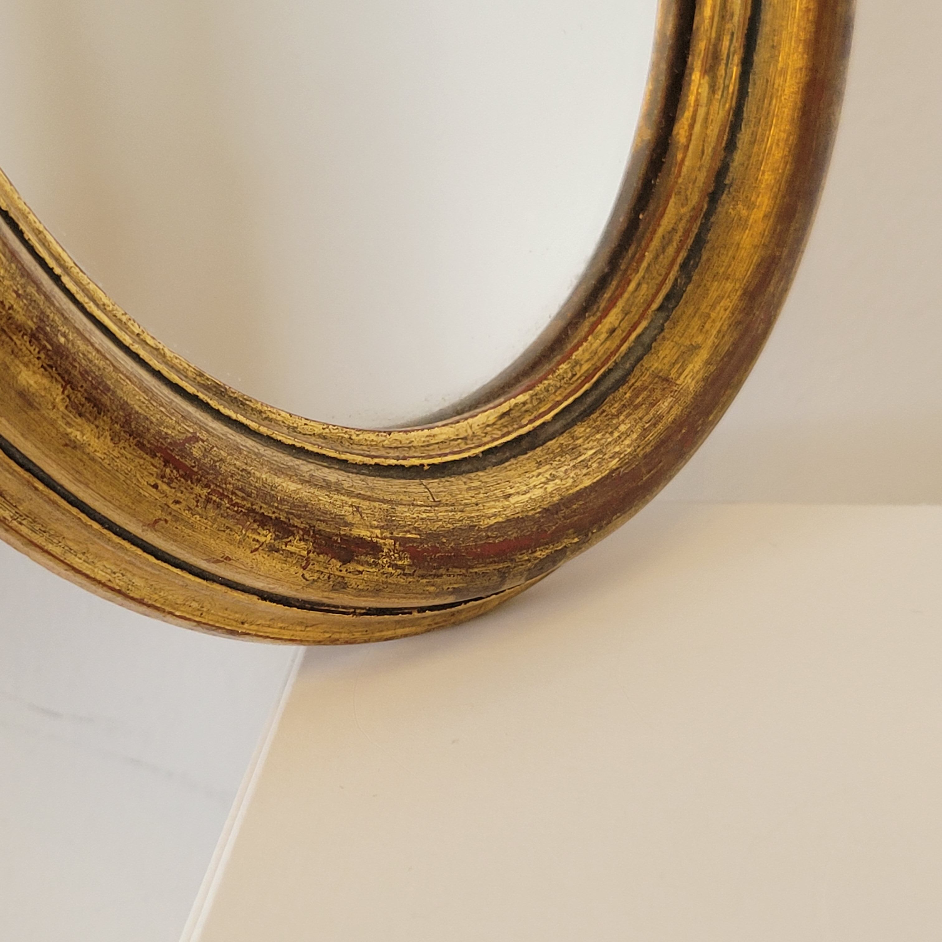 Old small oval mirror gilded wooden frame 22 X 17 X 2 cm.