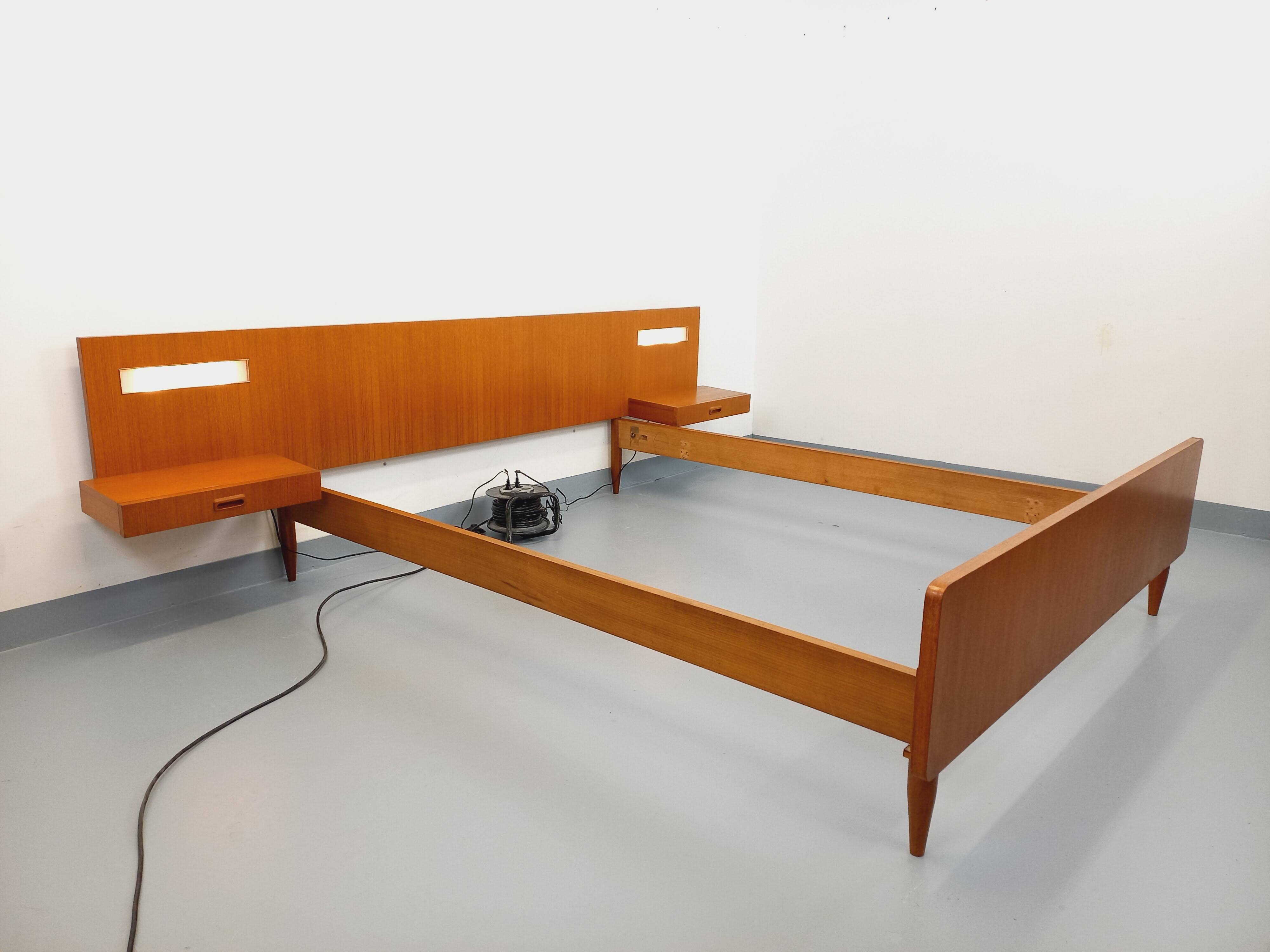 Double bed in vintage Scandinavian style from the 1960s with bedside tables.